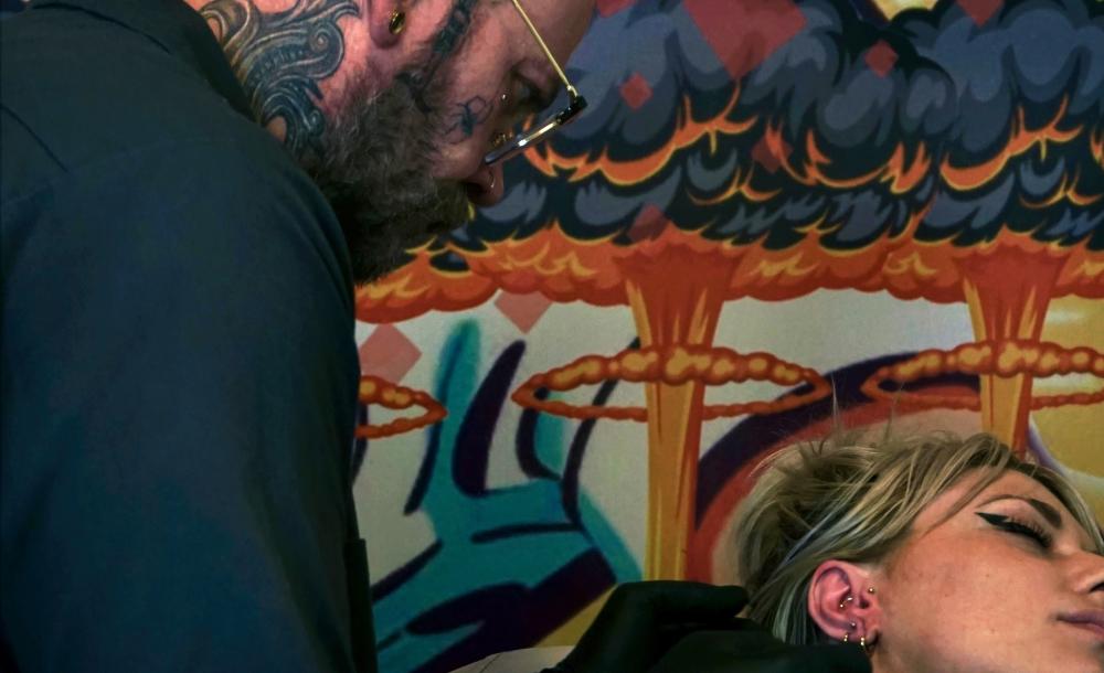 Man piercing woman